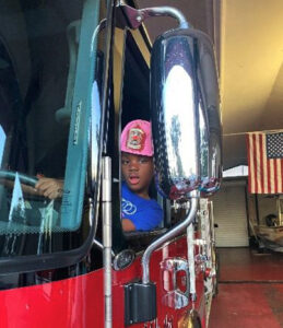 girl inside firetruck